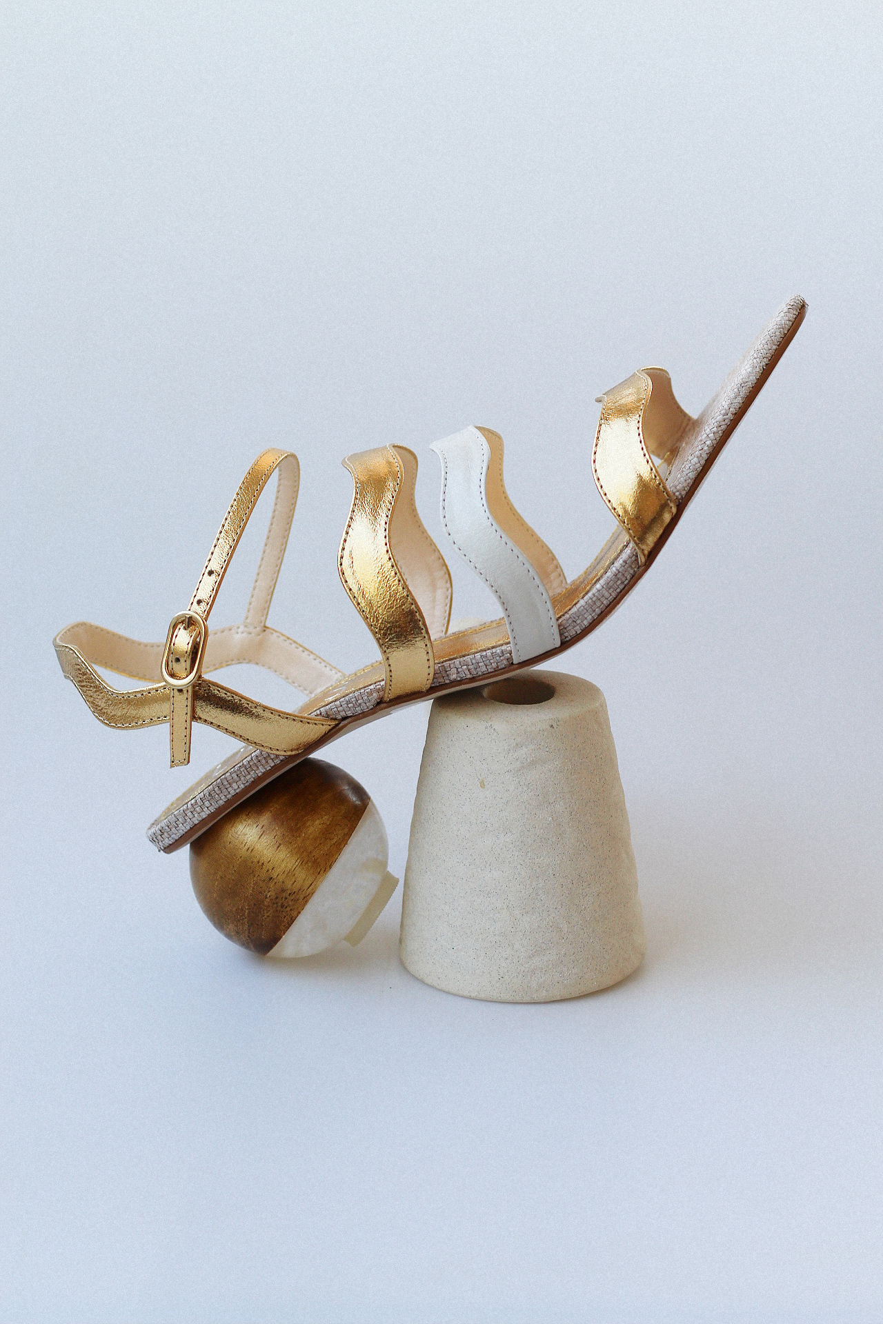 Gaspea sandal in gold and off-white with acrylic sphere heel and chestnut wood.