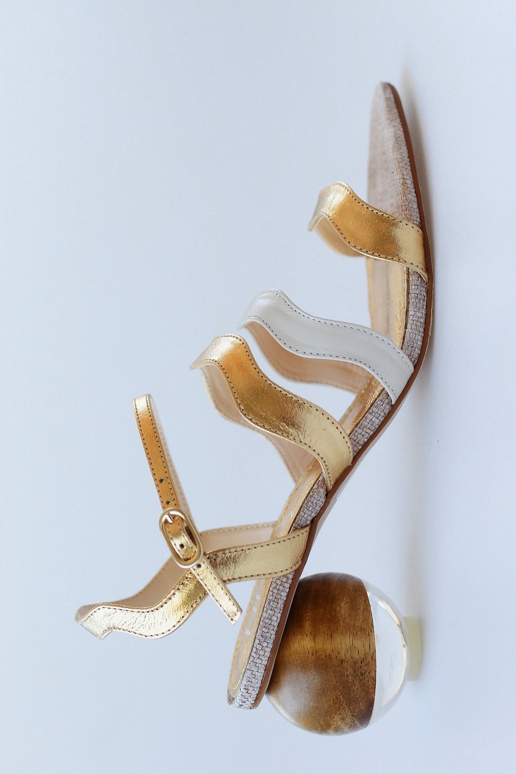 Gaspea sandal in gold and off-white with acrylic sphere heel and chestnut wood.