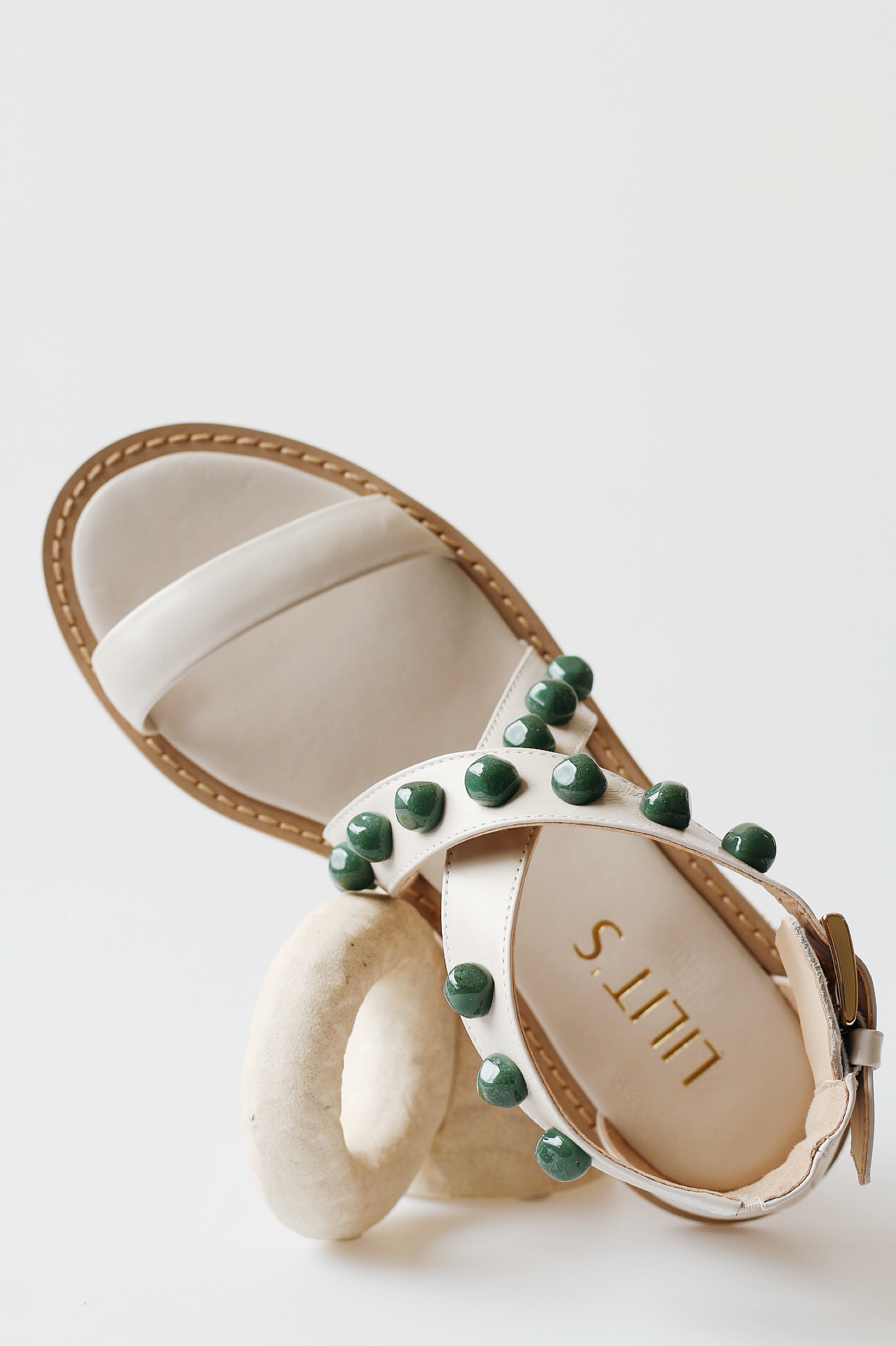 Off-white emerald sandal with green stones.