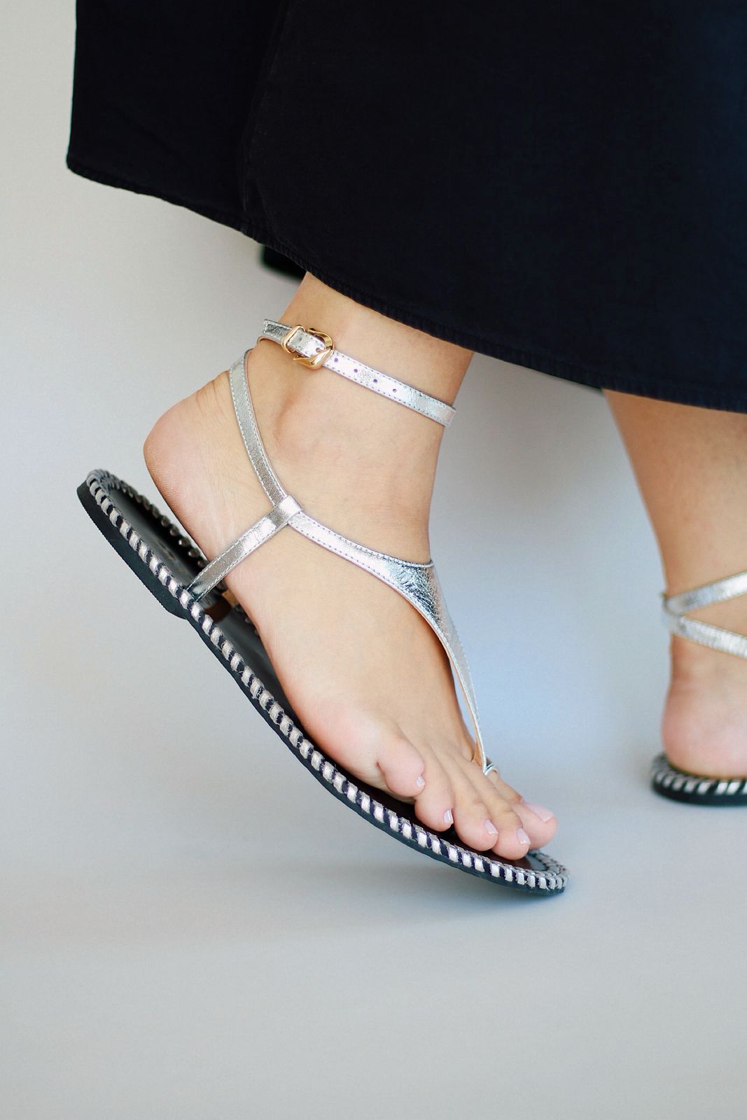 Olivia silver flat sandal with crochet detail on the side.