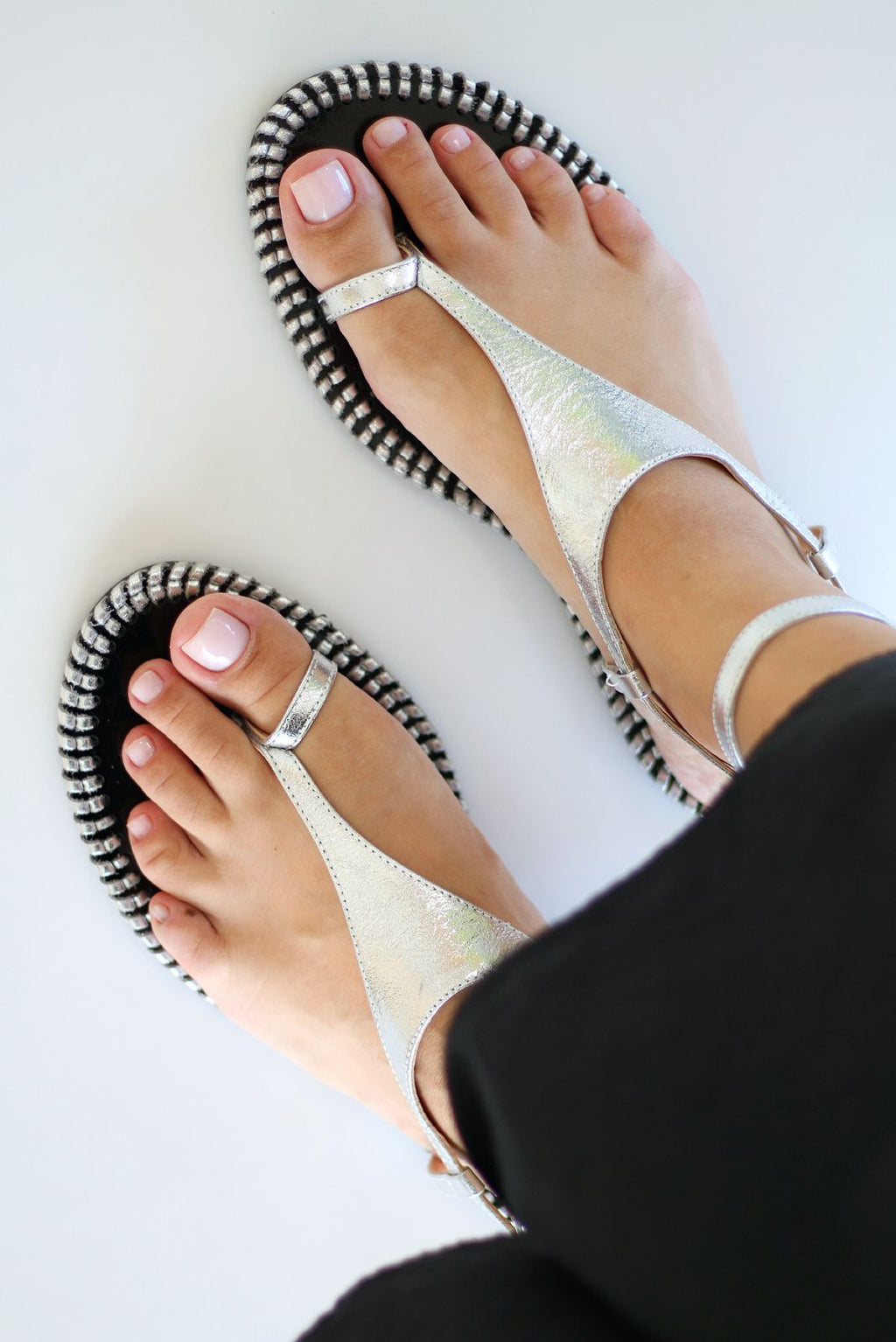 Olivia silver flat sandal with crochet detail on the side.